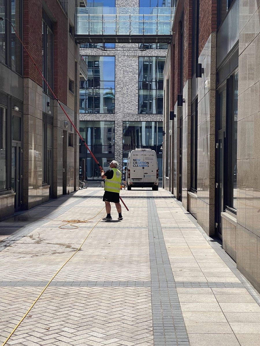 New Creation Cleaning crew member water-fed pole cleaning a Dublin commercial building