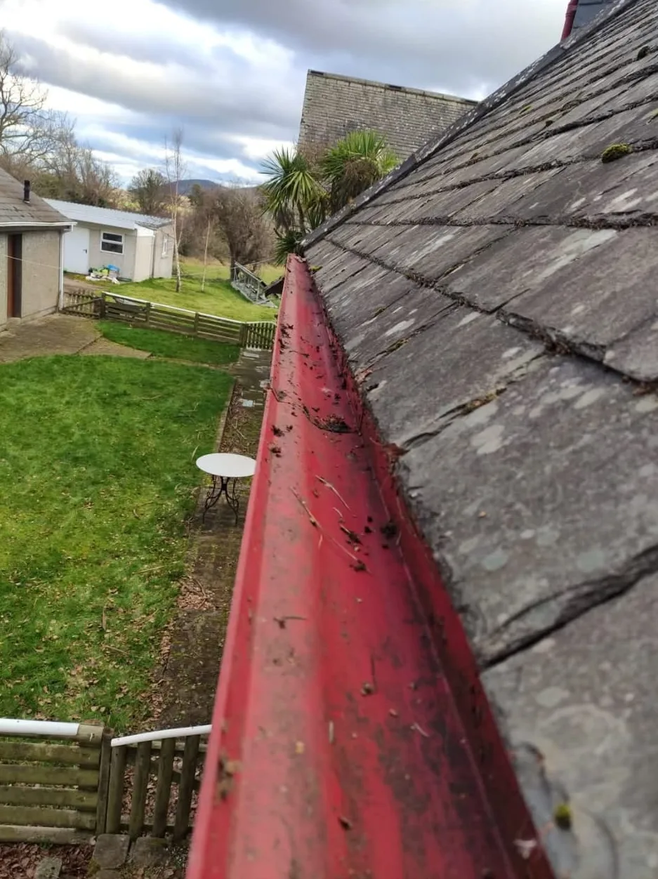 The same gutter run cleared and flowing freely