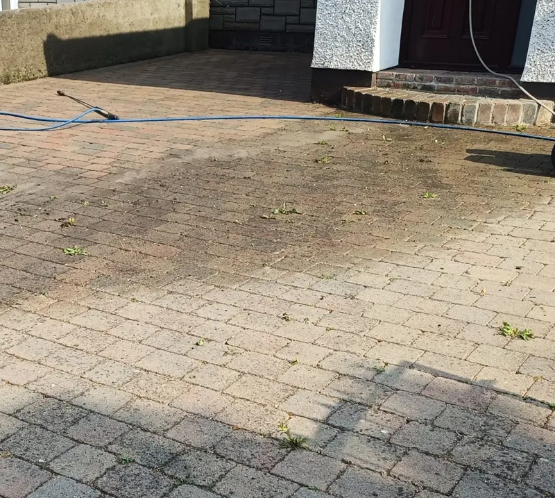 Block paving mid power wash, clean section beside the dirty one
