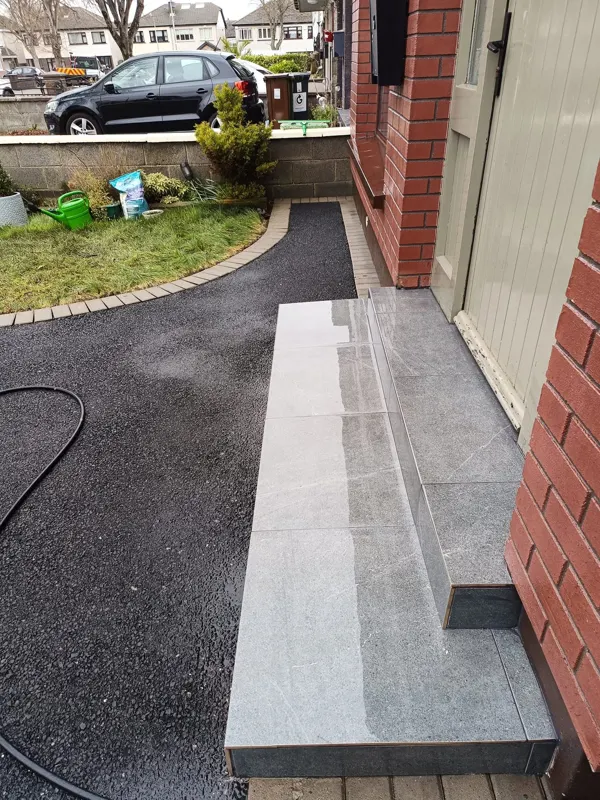 Tarmac path by the front steps cleaned back to black