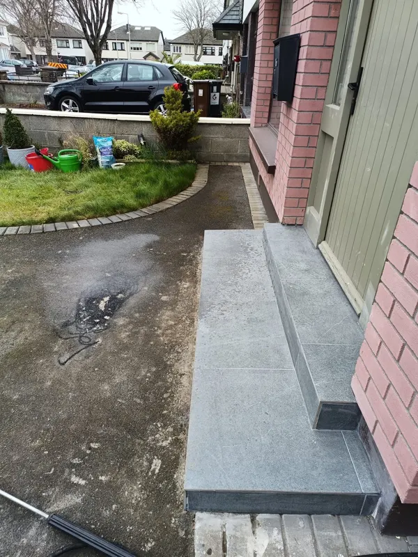 Tarmac path by the front steps stained and faded