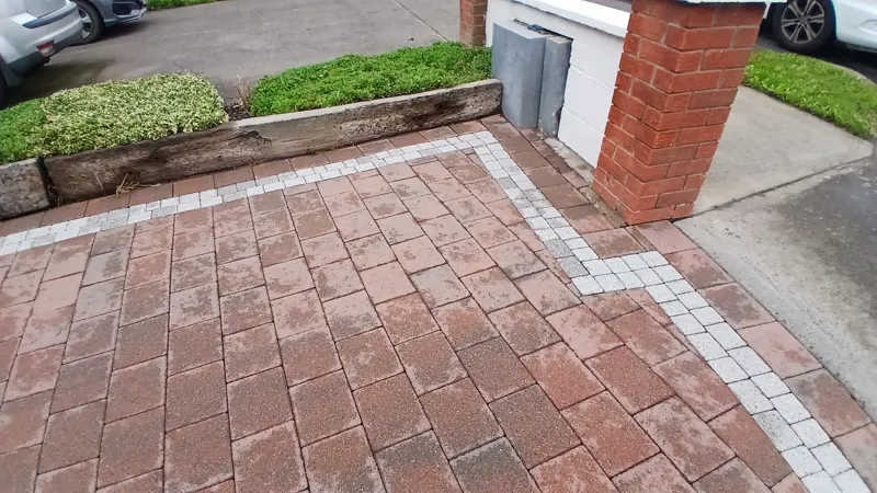 Stage 2 — the same corner power washed once the weeds had died off