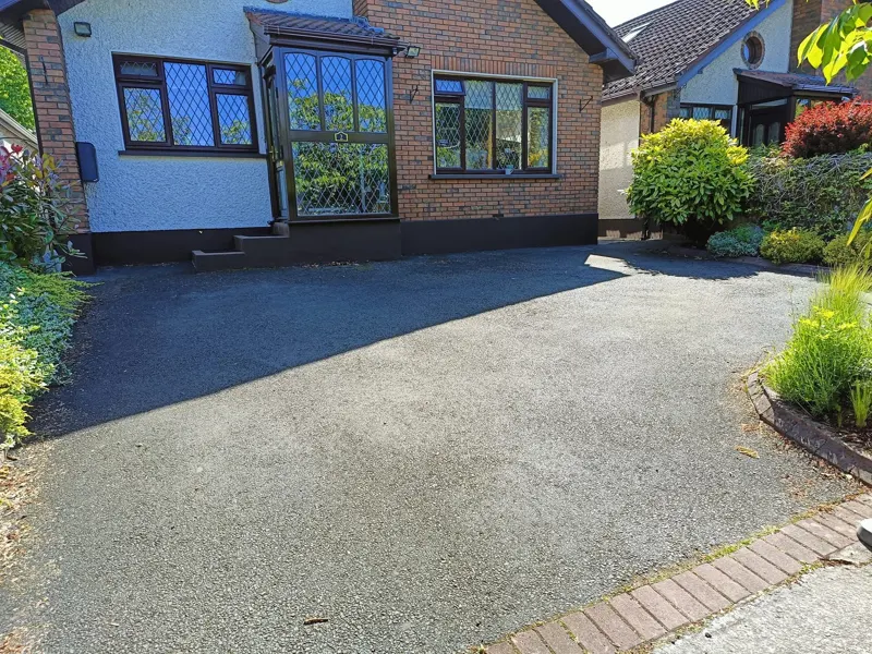 Before — tarmac driveway faded to grey and patchy in the sun